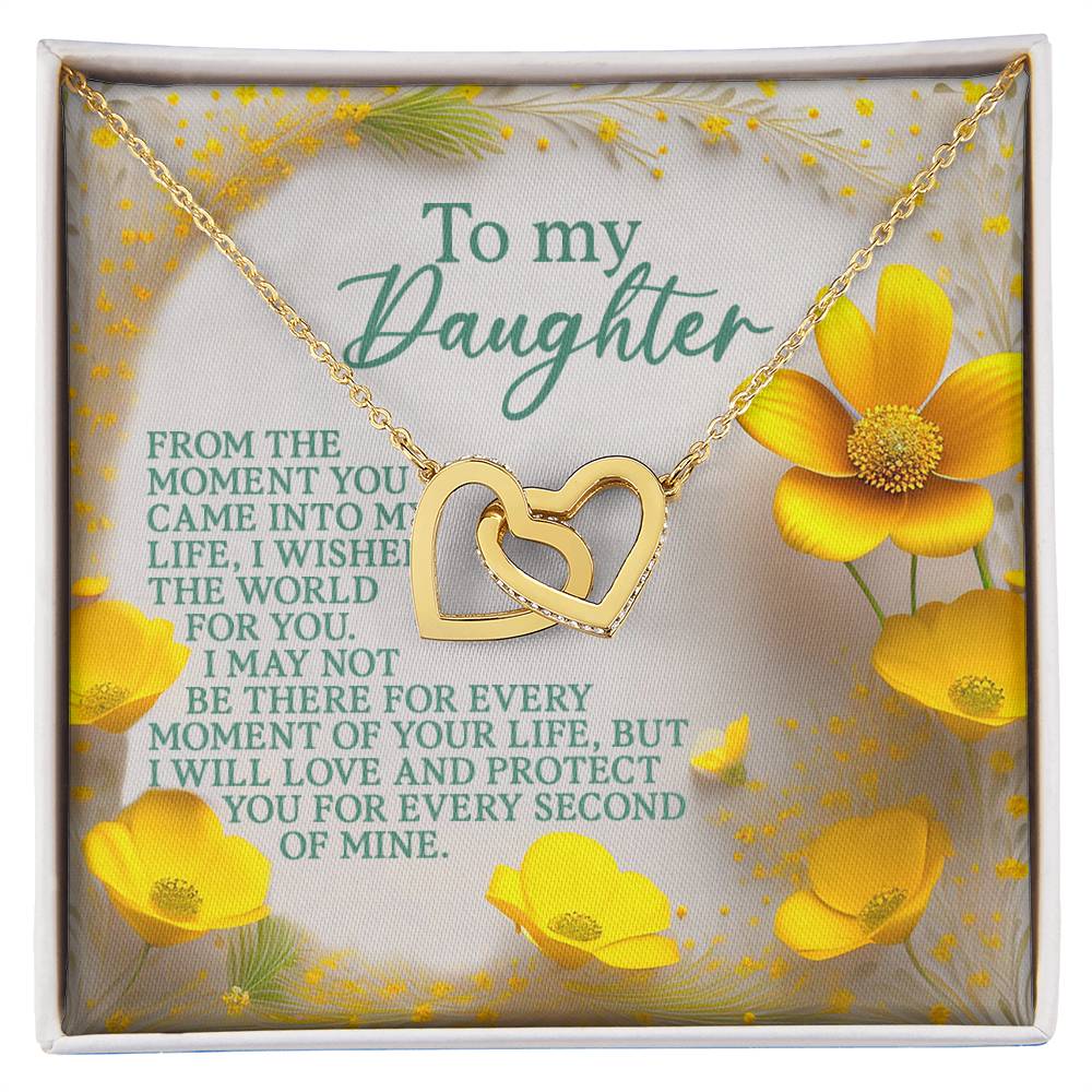 The Daughter-Every Moment Interlocking Hearts Necklace, with a rose gold finish and cubic zirconia crystals, rests on a decorative card featuring yellow flowers. The message reads: "To my Daughter. From the moment you came into my life, I wished the world for you...