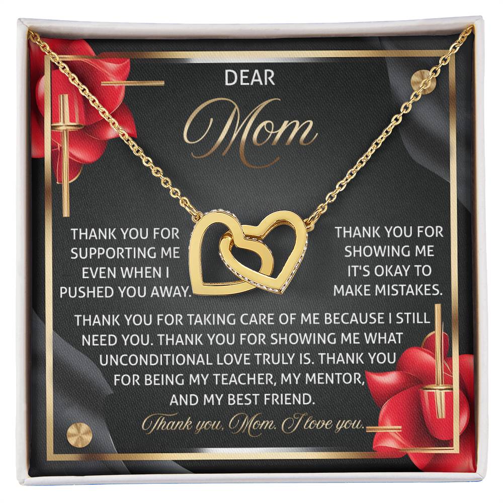 The Mom-Best Friend 2 - Interlocking Hearts Necklace, with a rose gold finish, is housed in a heartfelt gift box reading "Dear Mom... thank you for showing me it's okay to make mistakes," adorned with intricate red rose designs.