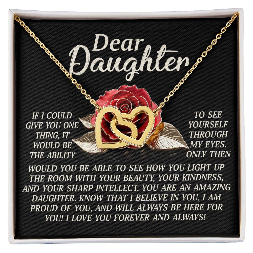 The Daughter-Your Light Interlocking Hearts Necklace features a gold finish and adjustable length. Displayed on a black background with a red rose, it delivers a heartfelt message from a parent to their daughter, expressing unwavering love, pride, and support.