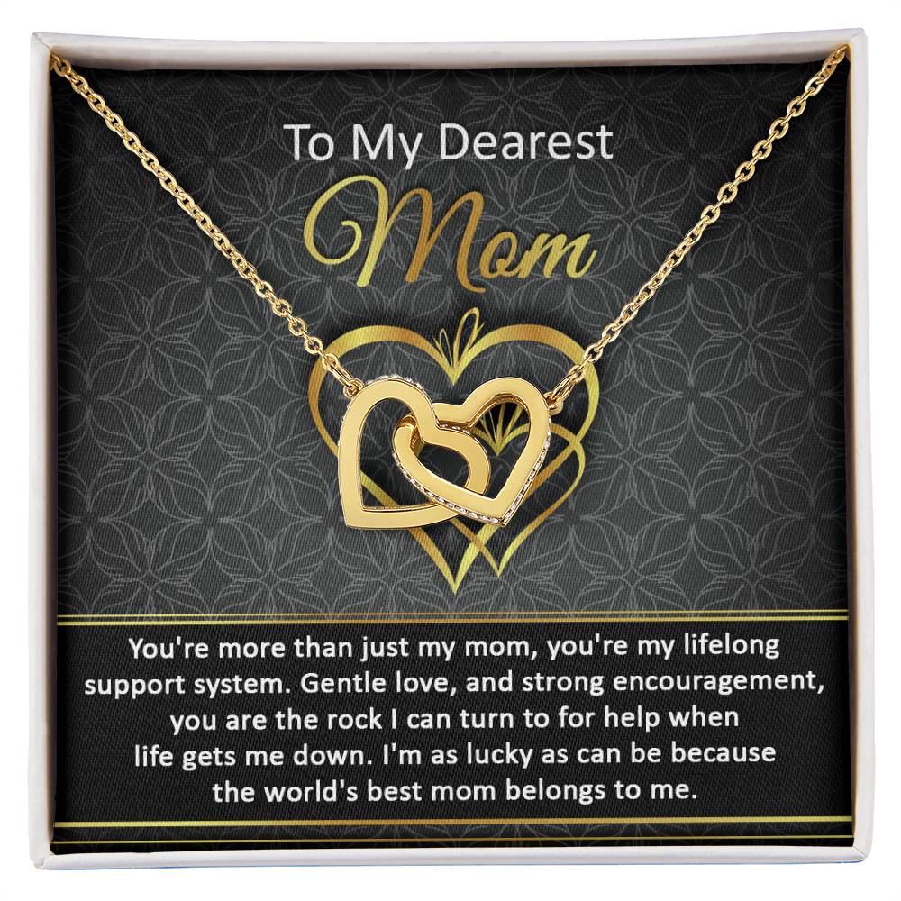 The To Mom, Belongs To Me2 - Interlocking Hearts Necklace features a gold heart pendant adorned with cubic zirconia crystals and comes in a box with an appreciative message for mom.