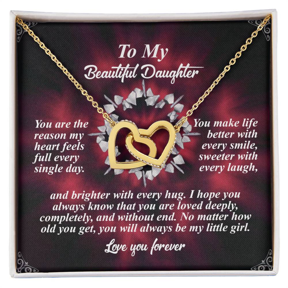 The Daughter-Every Hug Interlocking Hearts Necklace, embellished with cubic zirconia crystals, is displayed on a card featuring a dark floral background and a touching message of love for a daughter—an ideal gift for her.