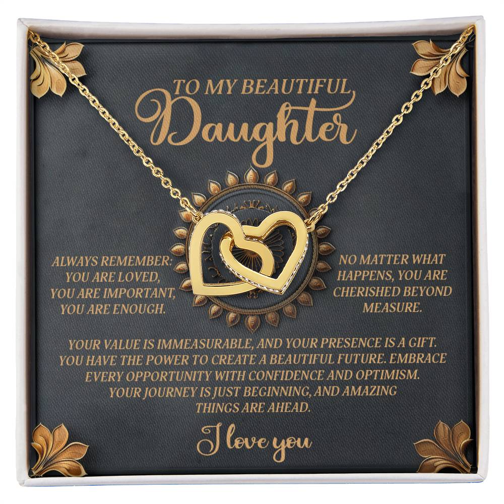 The Daughter-Beautiful Future necklace features interlocking hearts with an 18k yellow gold finish and cubic zirconia crystals, elegantly presented on a green card with gold accents. The card reads "To my beautiful daughter," accompanied by an inspiring message about love and optimism.