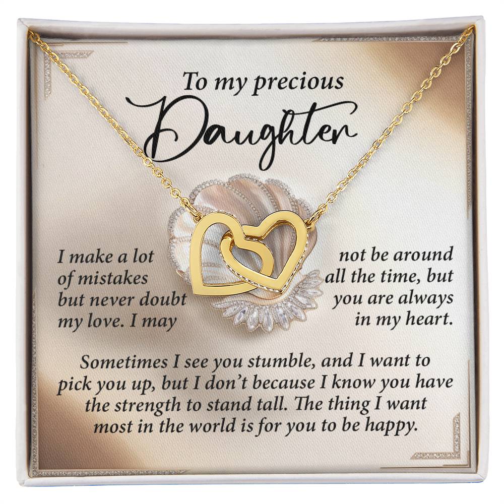 The Daughter-Be Happy - Interlocking Hearts Necklace, radiant with cubic zirconia crystals, rests in a jewelry box featuring a heartfelt message that reassures a daughter of unwavering love and eternal presence, even when you're apart.