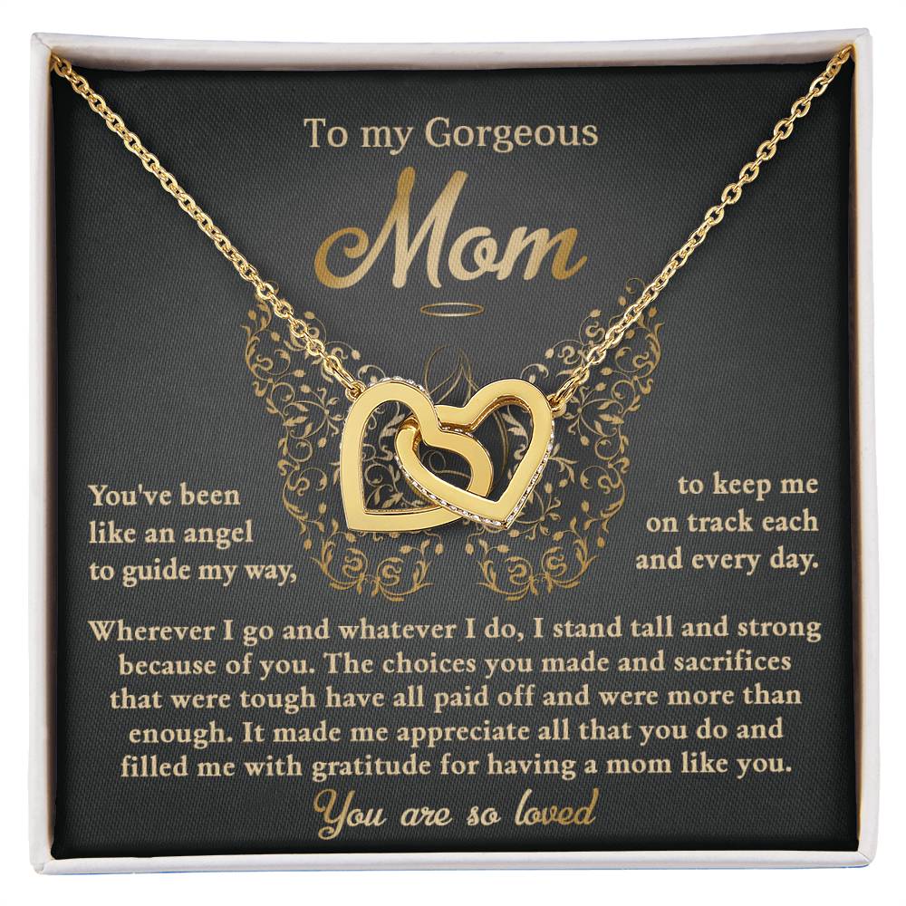 The "To Mom, Like An Angel - Interlocking Hearts Necklace" features cubic zirconia crystals and a card reading "To my Gorgeous Mom," making it a special gift that expresses endless appreciation and love.