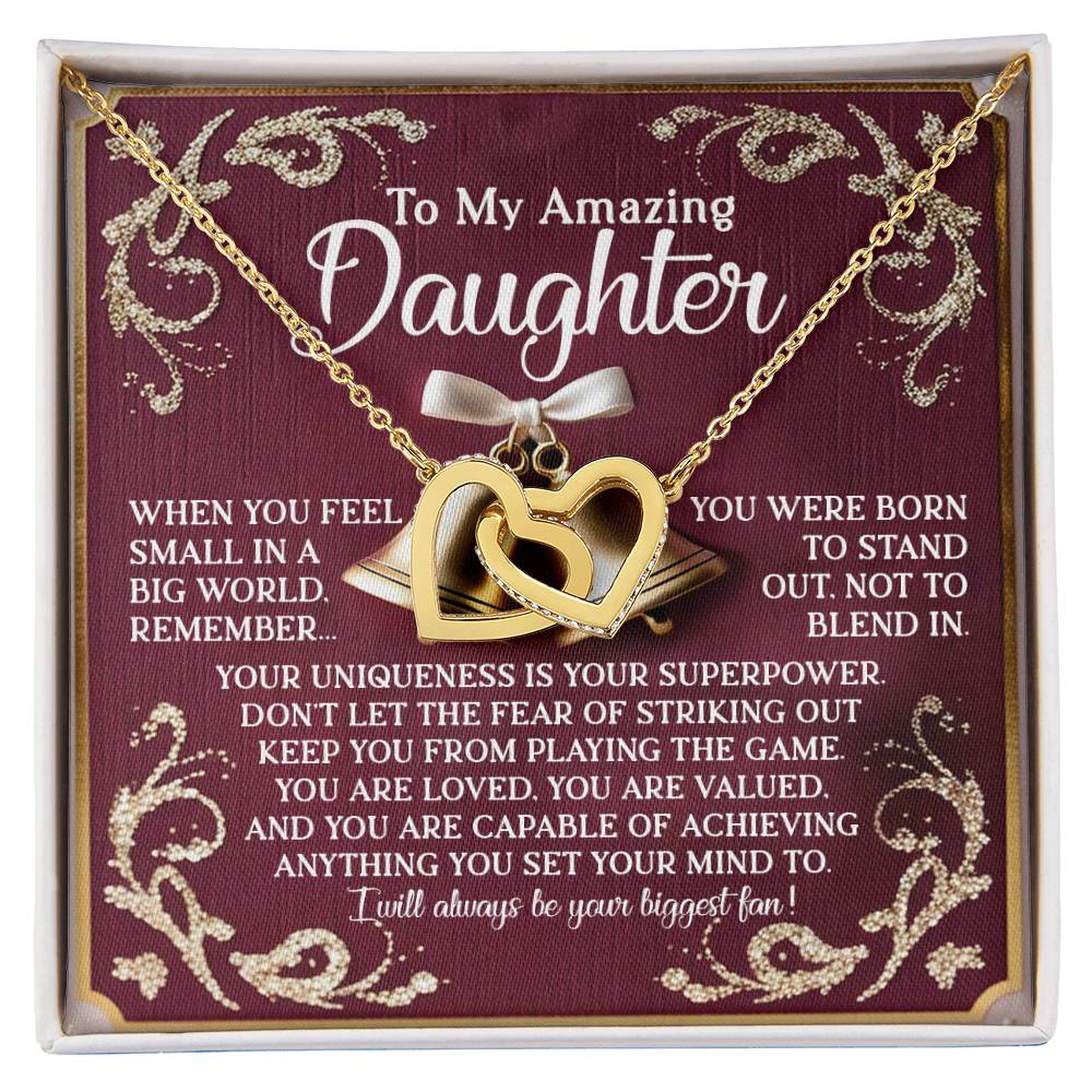 The "Daughter-Stand Out" Interlocking Hearts Necklace features shimmering cubic zirconia crystals and is displayed on a red card. It encourages your daughter to embrace her uniqueness, promoting self-love and individuality while assuring her of your support and belief in her abilities.