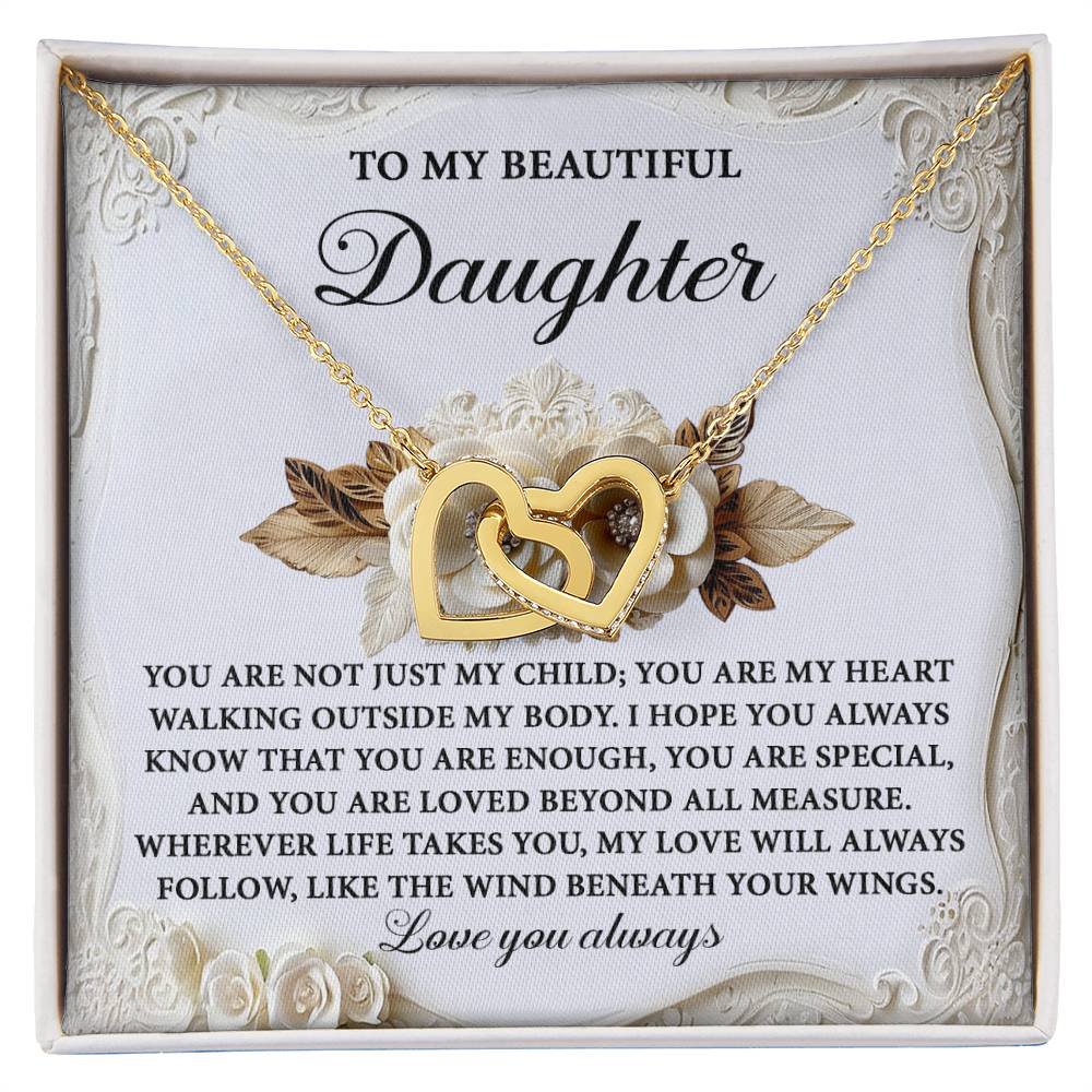 The Daughter-Beneath Your Wings - Interlocking Hearts Necklace features a gold interlocking hearts design with a rose gold finish, cubic zirconia crystals, and comes on a padded card titled "To My Beautiful Daughter" with an emotional message about love and support.