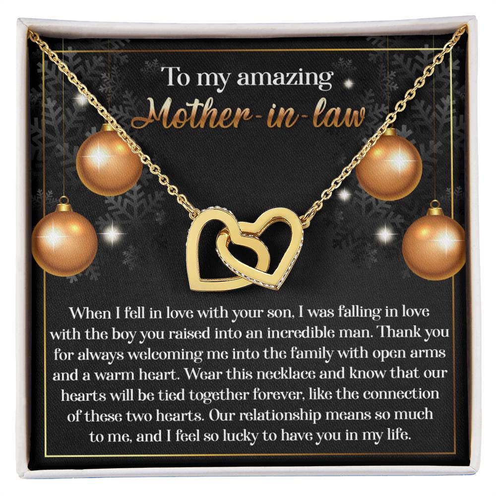 The Mother-in-Law-Two Hearts - Interlocking Hearts Necklace, featuring a rose gold finish and set in a gift box with an affectionate message for a mother-in-law, is embellished with decorative gold accents and dazzling cubic zirconia crystals.