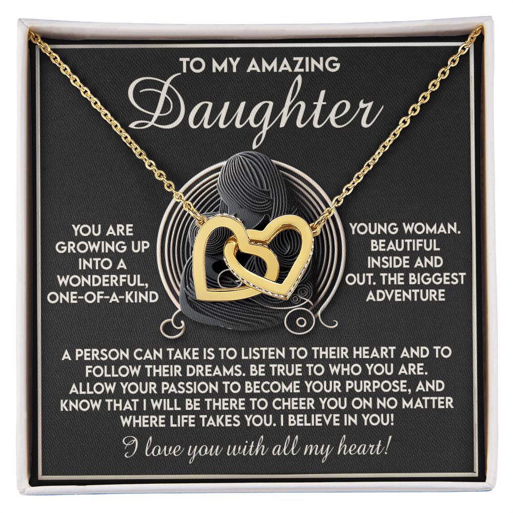 The Daughter-Your Dreams Interlocking Hearts Necklace, with a rose gold finish and sparkling cubic zirconia crystals, comes in a box featuring a heartfelt message to a daughter about love, dreams, and life's journey.