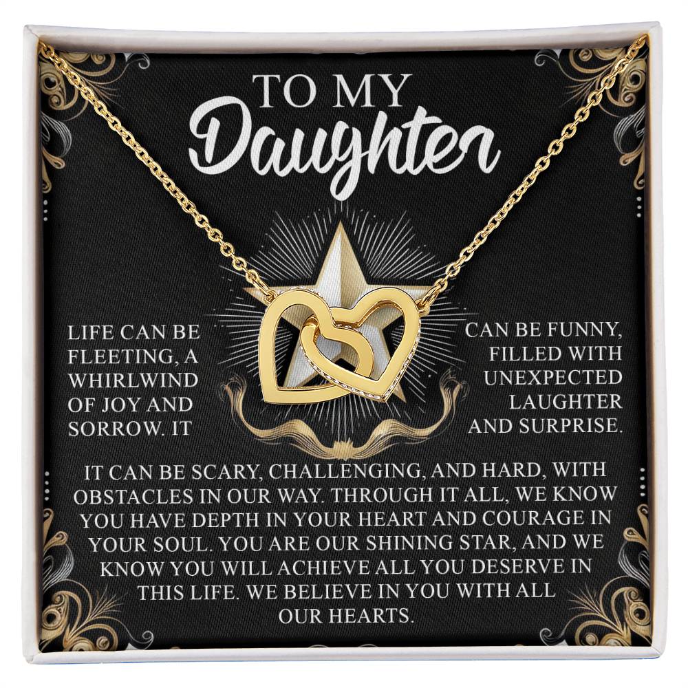 The Daughter-Shining Star Interlocking Hearts Necklace in gold, featuring cubic zirconia crystals, is presented in a gift box with decorative text "To My Daughter," accompanied by an inspirational message about life's challenges and the recipient's inner strength.