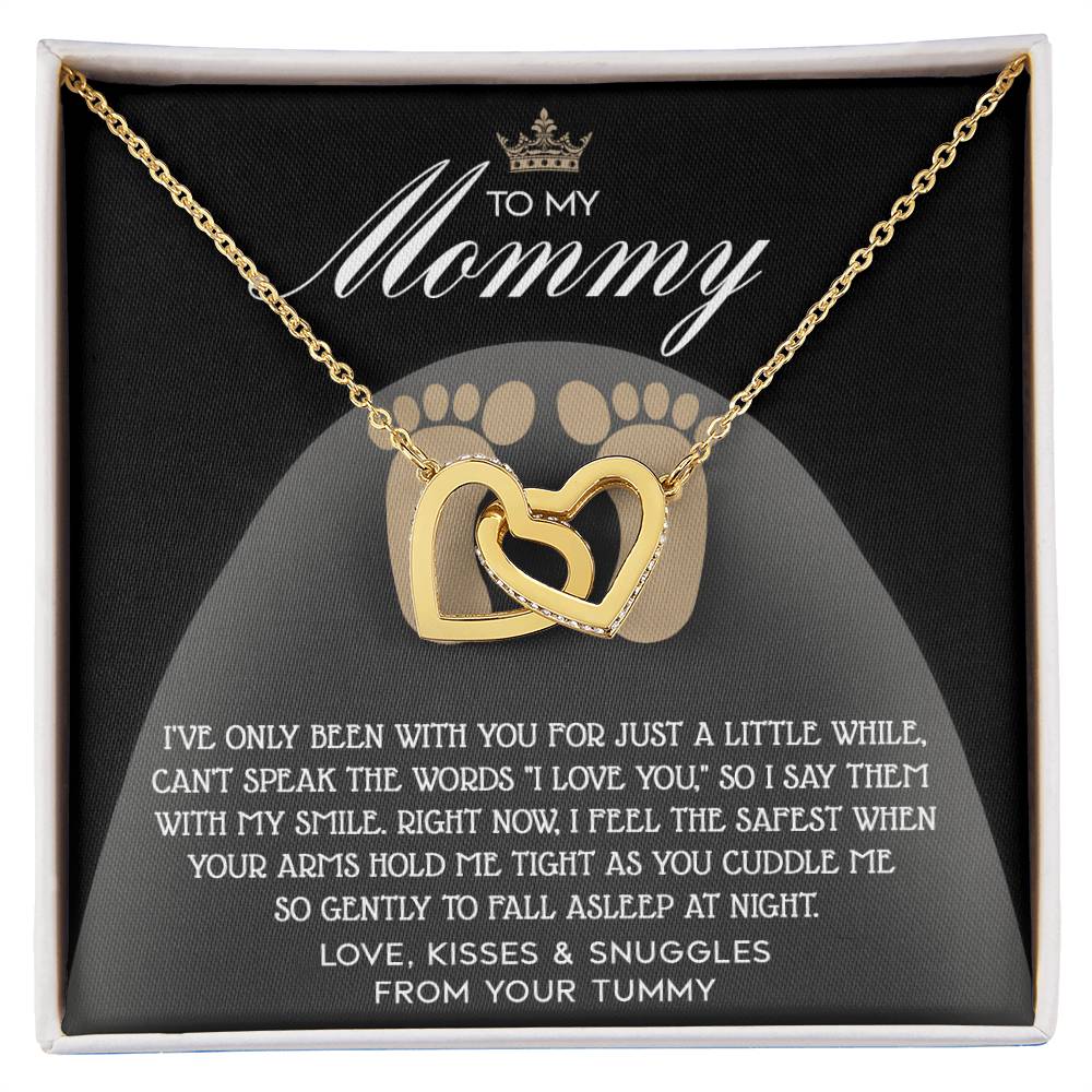 The "To Mama To Be, I Love You" Interlocking Hearts Necklace features a rose gold finish and cubic zirconia crystals, elegantly displayed on a card inscribed with "To My Mommy" and a heartfelt message.