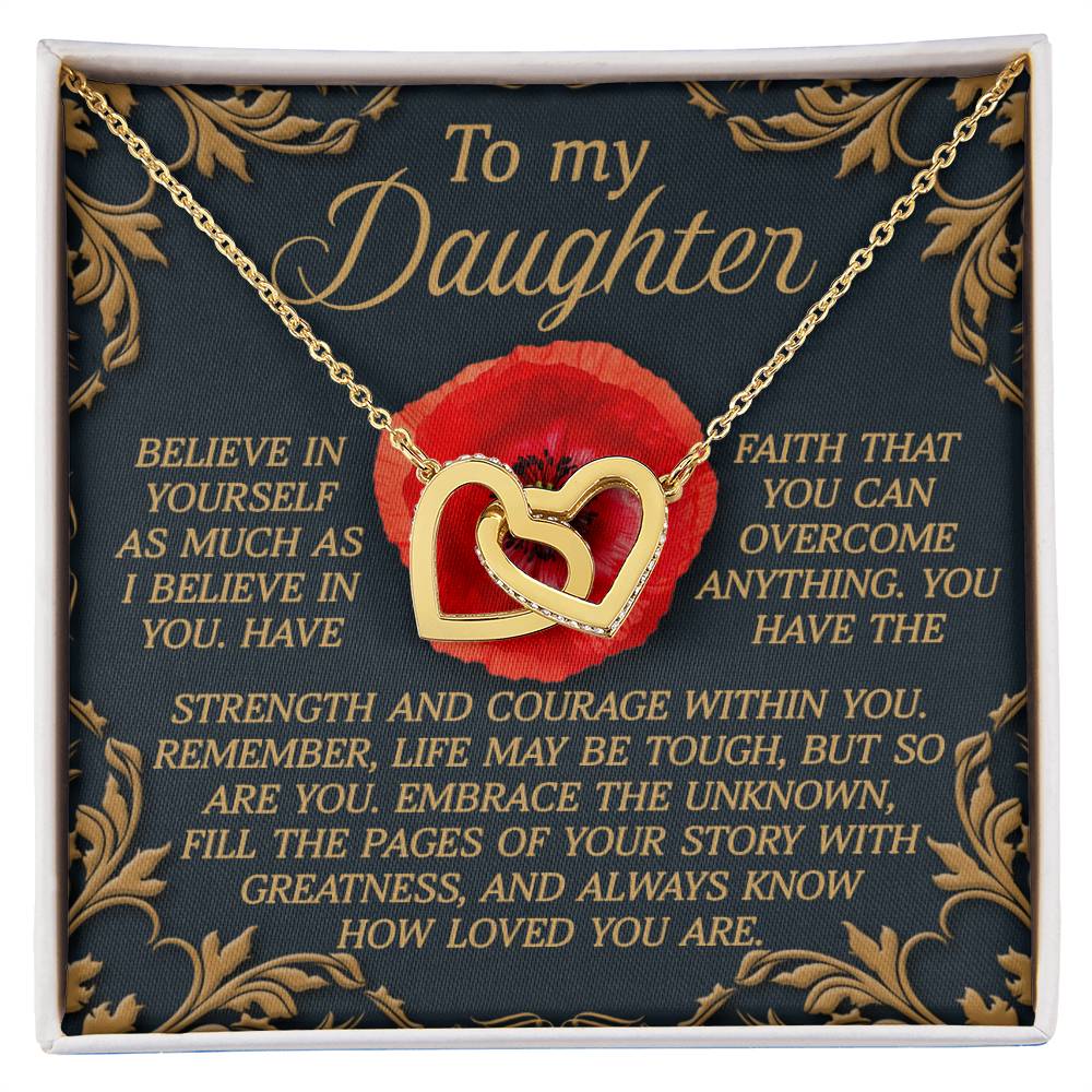 The "Daughter-With Greatness" Interlocking Hearts necklace, made of surgical steel with cubic zirconia crystals, comes in a box featuring a heartfelt message for a daughter against a vibrant red flower design, celebrating belief, faith, strength, courage, and love.
