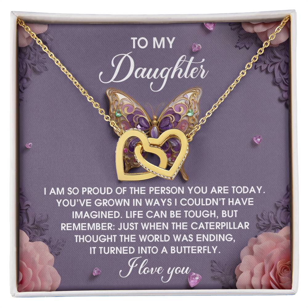 The Daughter-A Butterfly - Interlocking Hearts Necklace features intertwined hearts and a butterfly pendant with cubic zirconia crystals in rose gold, presented on a box with a heartfelt message to a daughter about growth and transformation.