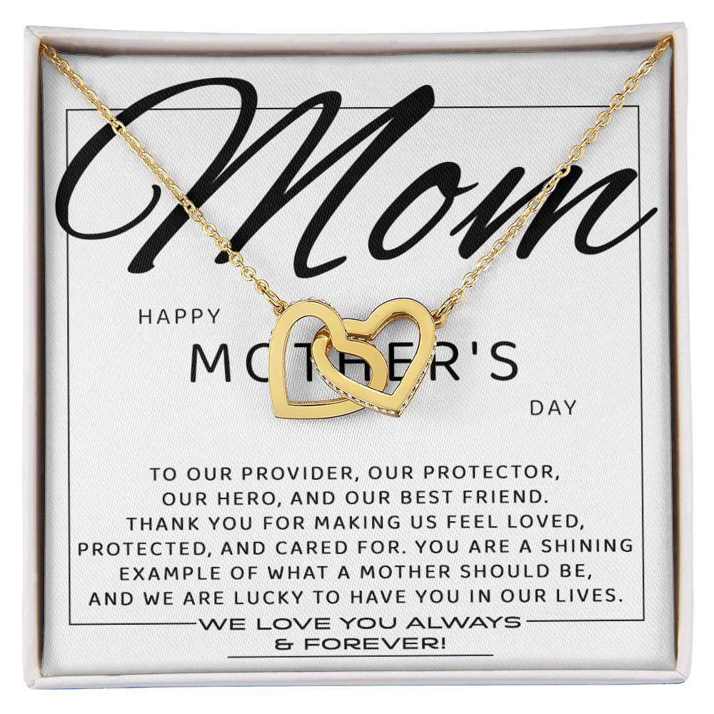 To Mom, Our Best Friend - Interlocking Hearts Necklace features a gold heart with cubic zirconia crystals on a display card, perfect for a heartfelt Mother’s Day gift.