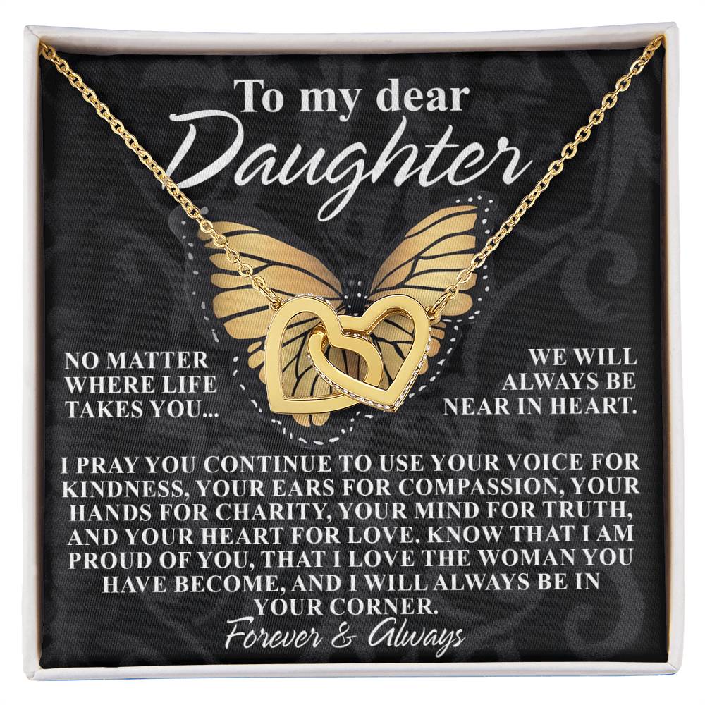 The Daughter-In Your Corner - Interlocking Hearts Necklace features a rose gold heart-shaped pendant with cubic zirconia crystals and a butterfly design. Set against a black background, it reads: "To my dear Daughter... Forever & Always," promoting kindness, love, and unwavering support.