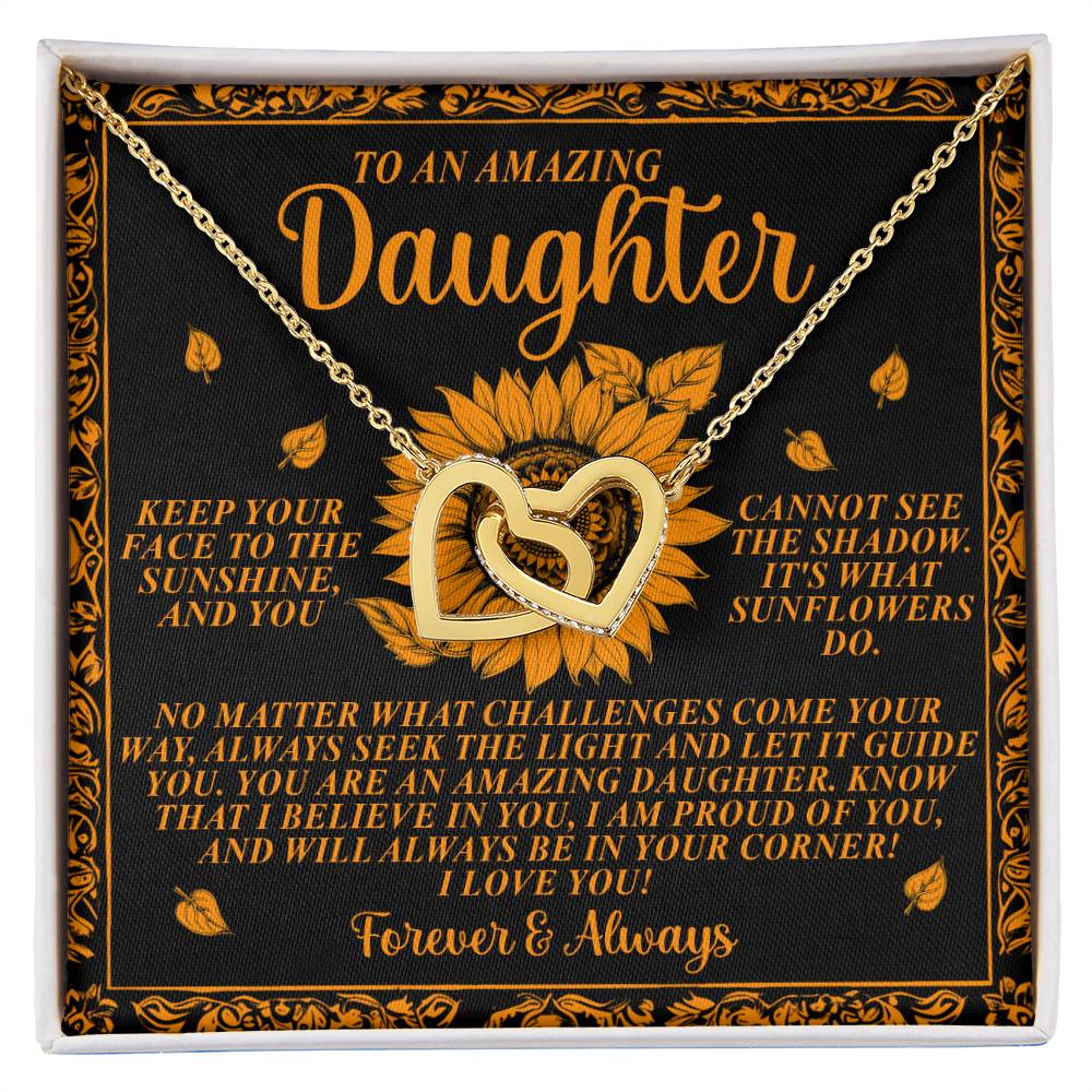 The Daughter-Seek Light - Interlocking Hearts Necklace features golden hearts and sunflowers on a decorative card. The card, with an orange sunflower design, offers words of love and encouragement, making it a perfect gift for her.