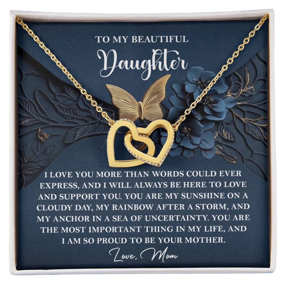 The Daughter-In My Life - Interlocking Hearts Necklace showcases a gold heart and butterfly with shimmering cubic zirconia crystals, presented on a card with a loving message to your daughter.