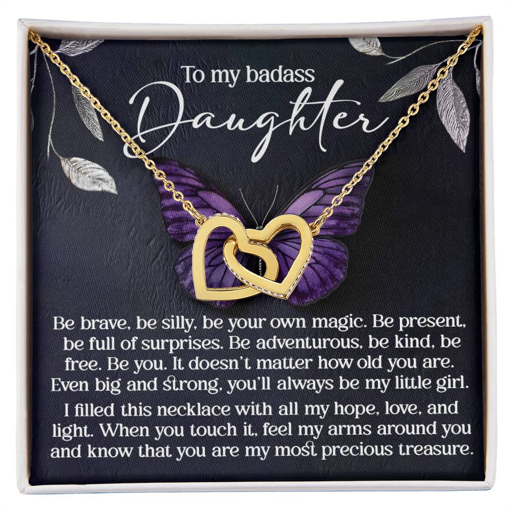 The Daughter-Big And Strong Interlocking Hearts Necklace features a rose gold finish, cubic zirconia crystals, and a purple butterfly card with an inspiring message for your daughter about bravery, strength, love, and pride.
