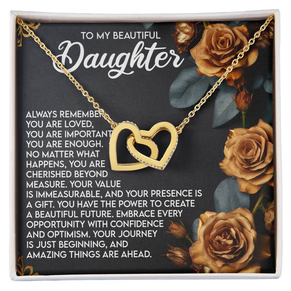 The Daughter-Loved Enough Interlocking Hearts Necklace features a gold finish on a dark floral background with the message: "To my beautiful daughter...always remember you are loved...embrace every opportunity...your journey is just beginning.