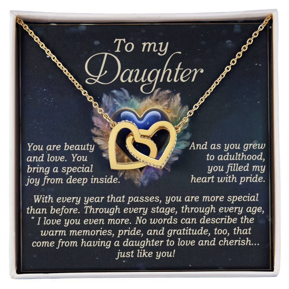 The Daughter-Like You - Interlocking Hearts Necklace, adorned with cubic zirconia crystals, is elegantly displayed in a box. The inscription reads: "To my Daughter. You are beauty and love... As you grew... With every year... I love you even more... To have a daughter to cherish just like you!.