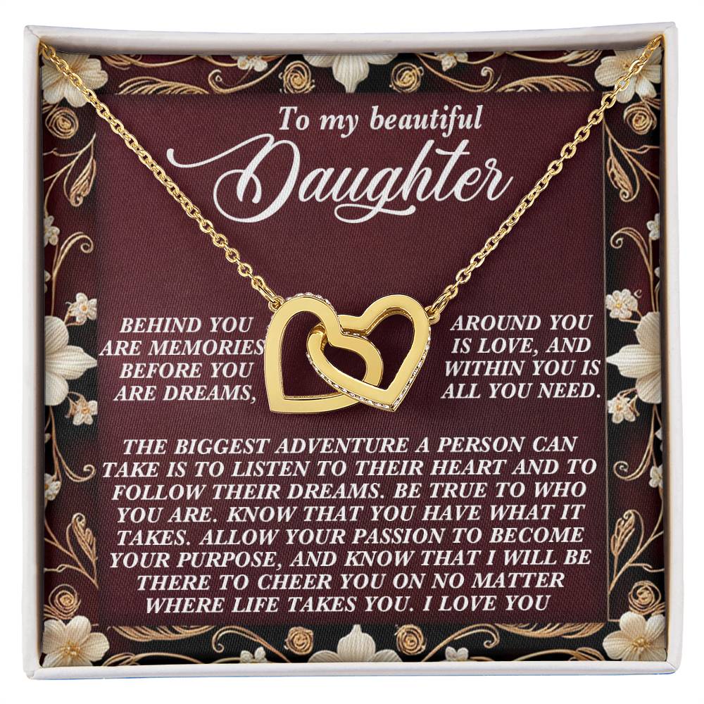 The Daughter-Follow Dreams - Interlocking Hearts Necklace, made with surgical steel and cubic zirconia crystals, comes on a floral card that reads: "To my beautiful daughter" and includes an inspirational message about love, dreams, and support.