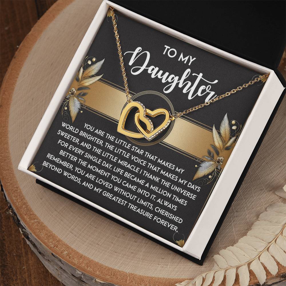 The Daughter-Greatest Treasure necklace, featuring interlocking hearts adorned with cubic zirconia crystals and crafted from surgical steel with a rose gold finish, comes in a jewelry box with a heartfelt message for your daughter.