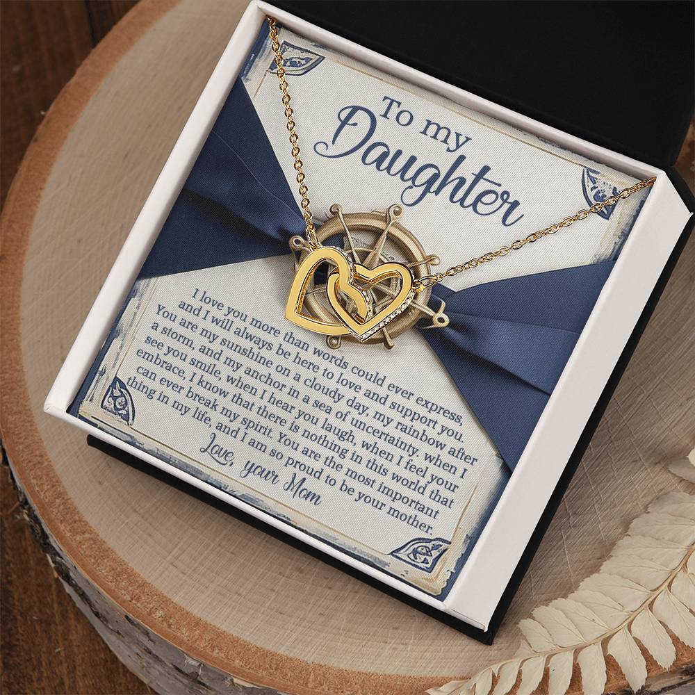 The Daughter-Sunshine Anchor - Interlocking Hearts Necklace, in a rose gold finish with cubic zirconia crystals, is nestled in a gift box featuring a nautical-themed note that beautifully conveys a mother's love and pride for her daughter.