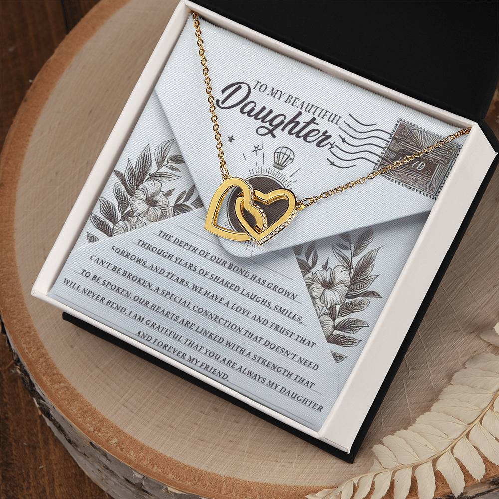 The Daughter-My Friend - Interlocking Hearts Necklace features a rose gold finish and cubic zirconia crystals. It comes in a gift box with floral designs and the message "To My Beautiful Daughter" in elegant script on the included card.