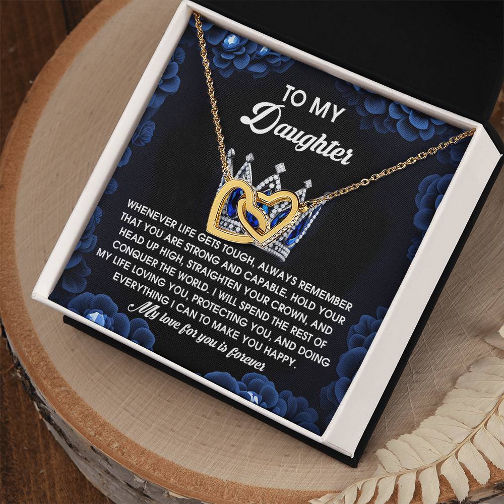 The "Daughter-Make You Happy - Interlocking Hearts Necklace" features rose gold-finished heart pendants adorned with cubic zirconia crystals. It arrives elegantly boxed with a supportive message set against a floral background.
