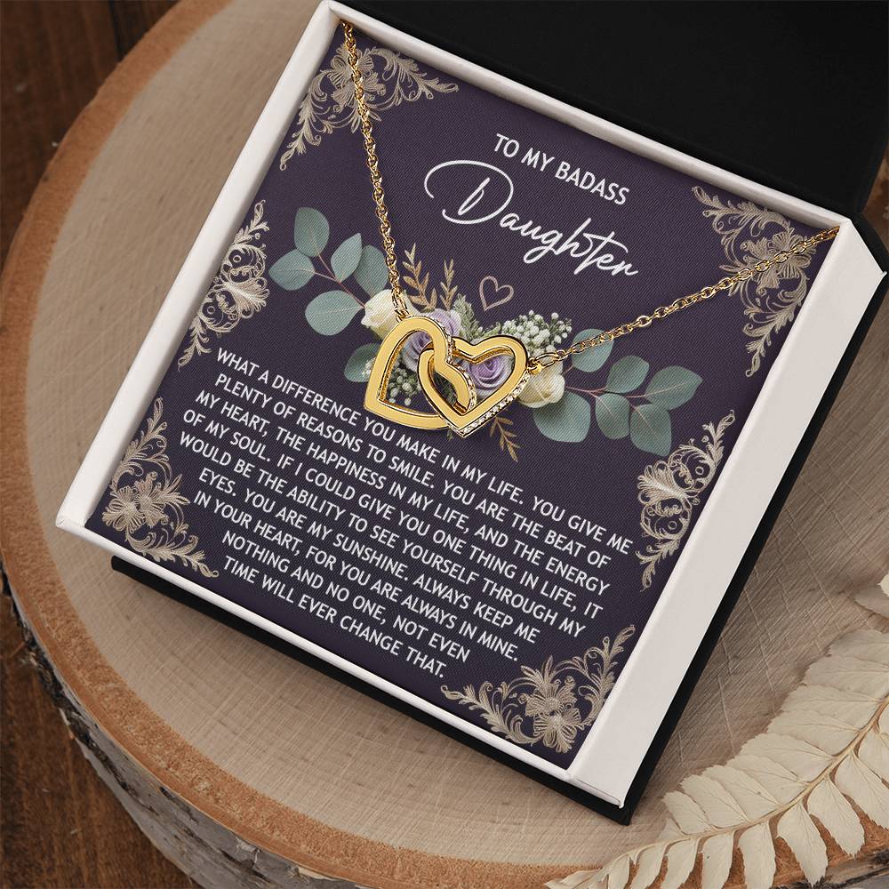 The Daughter-Always In Mine - Interlocking Hearts Necklace, featuring sparkling cubic zirconia and a dazzling rose gold finish, comes in a floral-designed gift box with the message "To My Badass Daughter.
