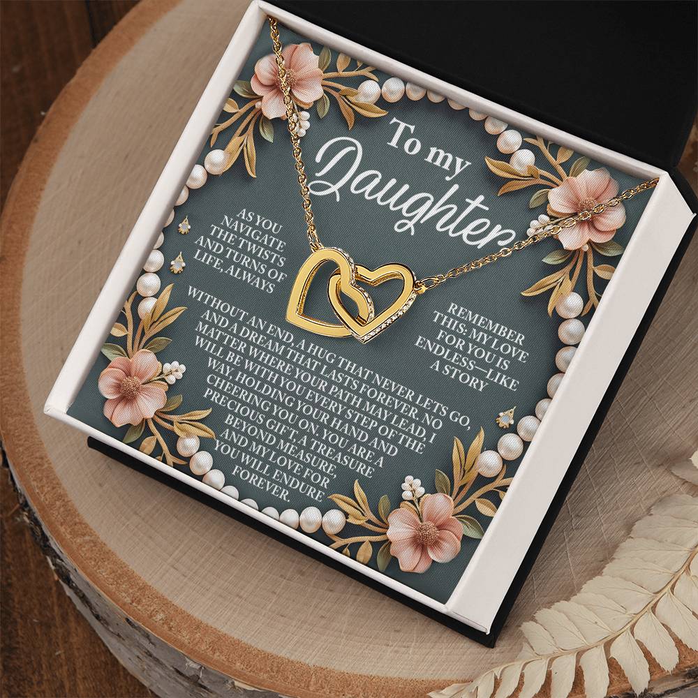 The gift box features a "To my Daughter" card with an inspiring message. Inside is the Daughter-Endless Love - Interlocking Hearts Necklace in rose gold, decorated with floral accents, pearls, and sparkling cubic zirconia, displayed open on a wooden surface.
