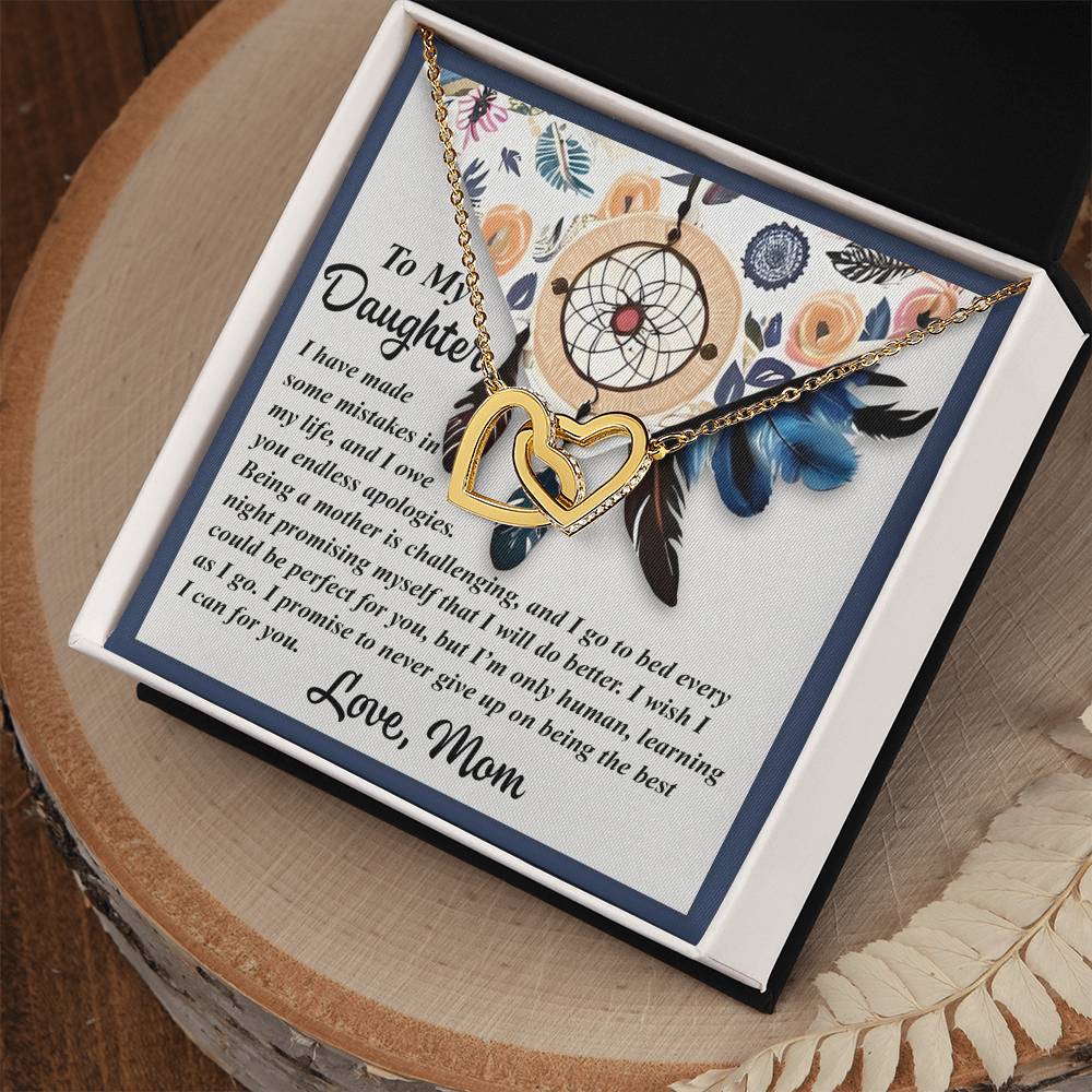 The Daughter-For You - Interlocking Hearts Necklace comes in a jewelry gift box, featuring a rose gold finish with cubic zirconia crystals. The background includes floral and dreamcatcher designs, along with a heartfelt note from mother to daughter expressing love and encouragement.