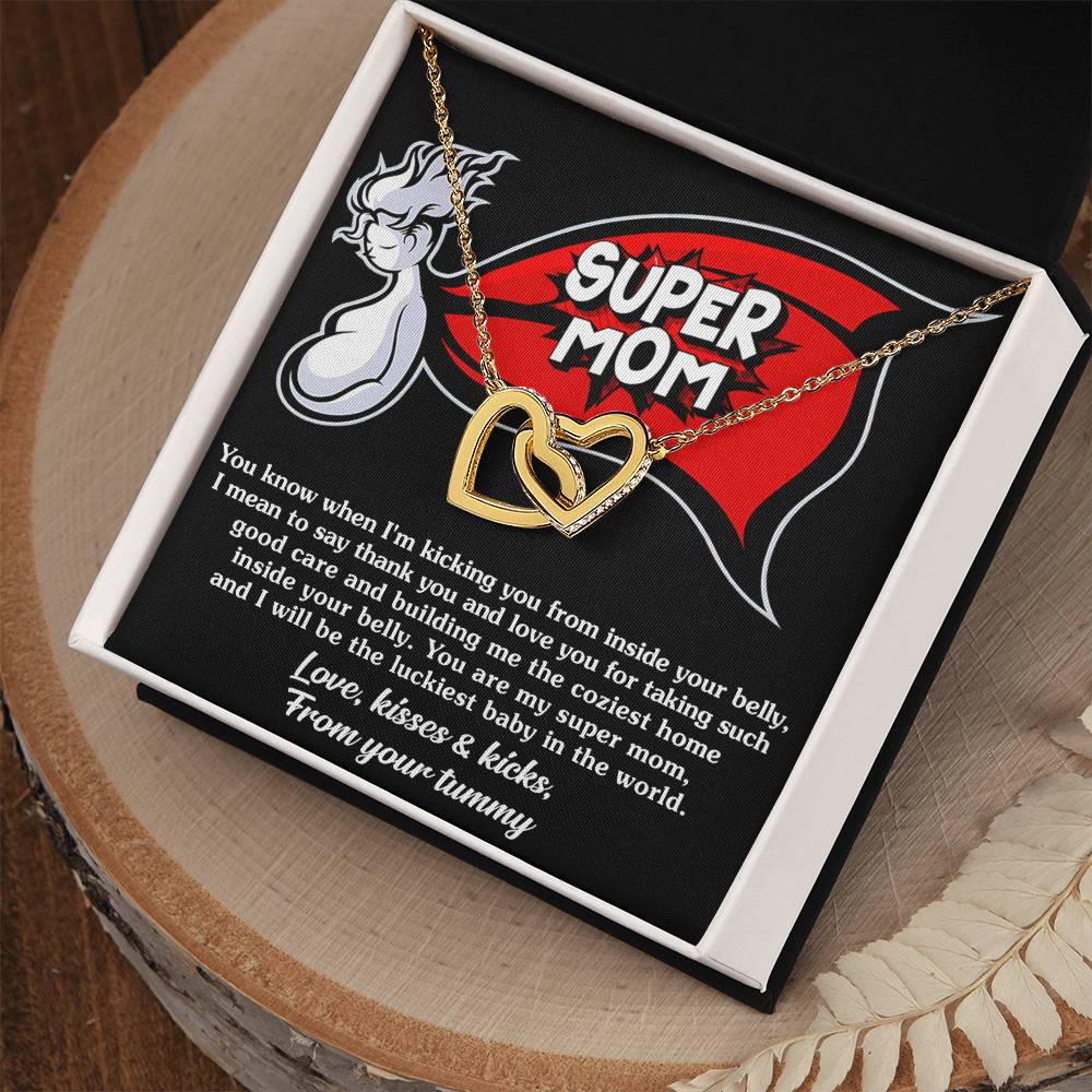 A To Mama To Be, My Super Mom - Interlocking Hearts Necklace, adorned with cubic zirconia crystals, displayed in a gift box with a "super mom" graphic and a loving message from an unborn baby to its mother.