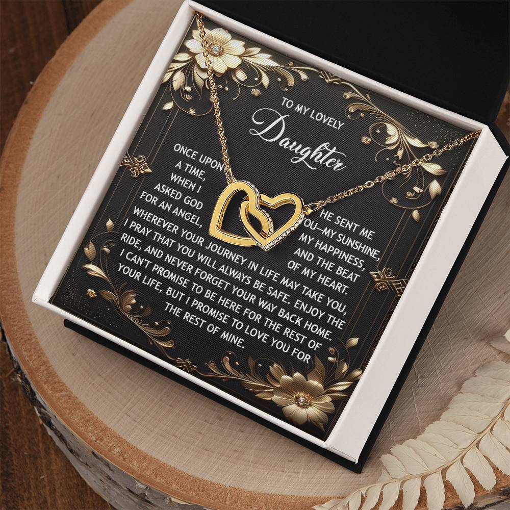 The Daughter-Be Safe Interlocking Hearts Necklace features a rose gold finish with sparkling cubic zirconia crystals. It comes in a box and includes a decorative card with flowers and a heartfelt message for your daughter.