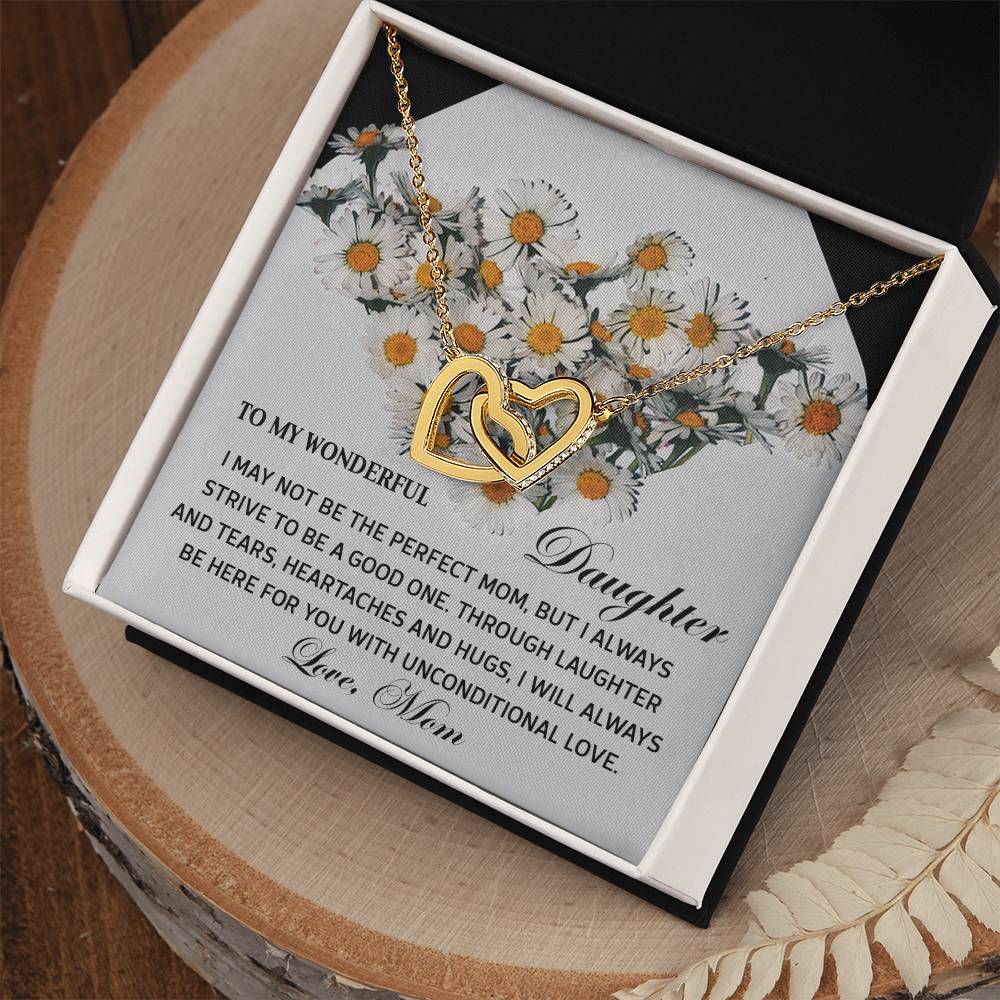 The Daughter-Unconditional Love - Interlocking Hearts Necklace features rose gold interlocking hearts with cubic zirconia crystals, elegantly presented on a message card adorned with flowers and a heartfelt note from mother to daughter.