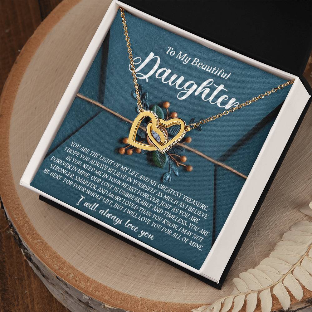 The Daughter-All Of Mine - Interlocking Hearts Necklace, sparkling with cubic zirconia crystals, is presented in an open box labeled "To My Beautiful Daughter" with a heartfelt message. A teal envelope design and decorative elements enhance the enchanting look.