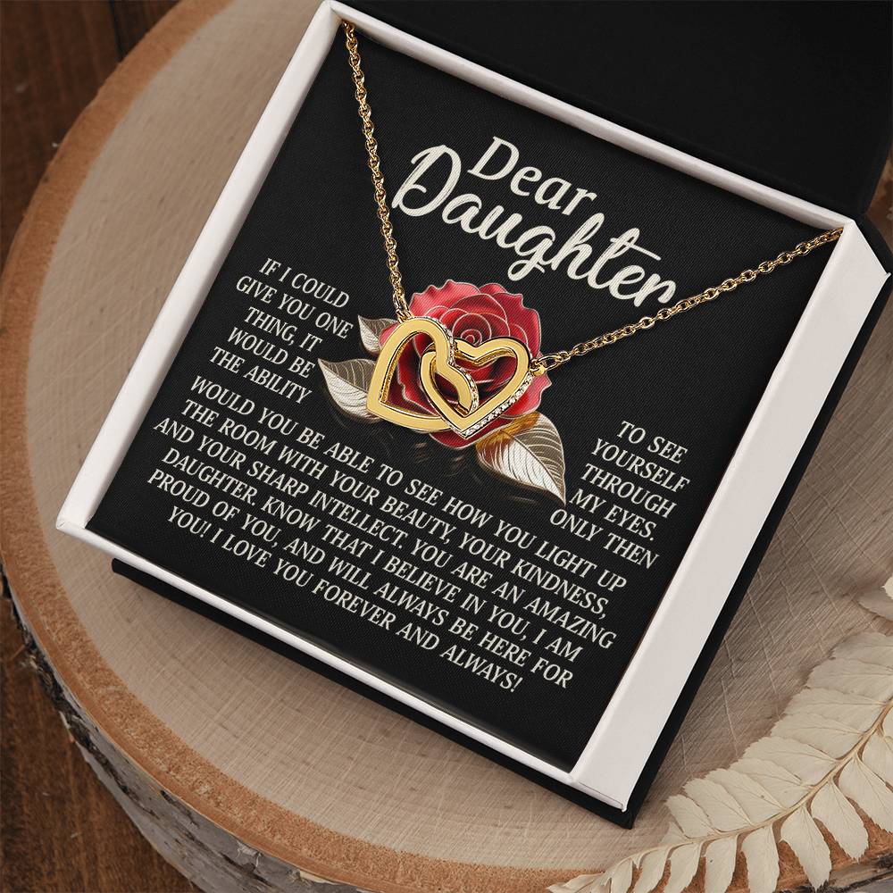 The "Daughter-Your Light" Interlocking Hearts Necklace with cubic zirconia crystals is presented on a display card featuring the message: "Dear Daughter: If I could give you one thing, it would be the ability to see yourself through my eyes," with a rose and leaf design.