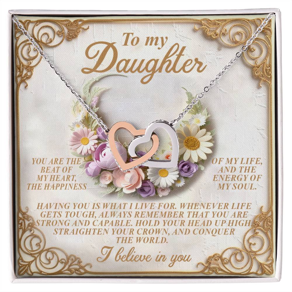The Daughter-Heart Happiness necklace features silver interlocking heart pendants and is presented on a card decorated with flowers and a heartfelt message starting with "To my Daughter" and ending with "I believe in you.