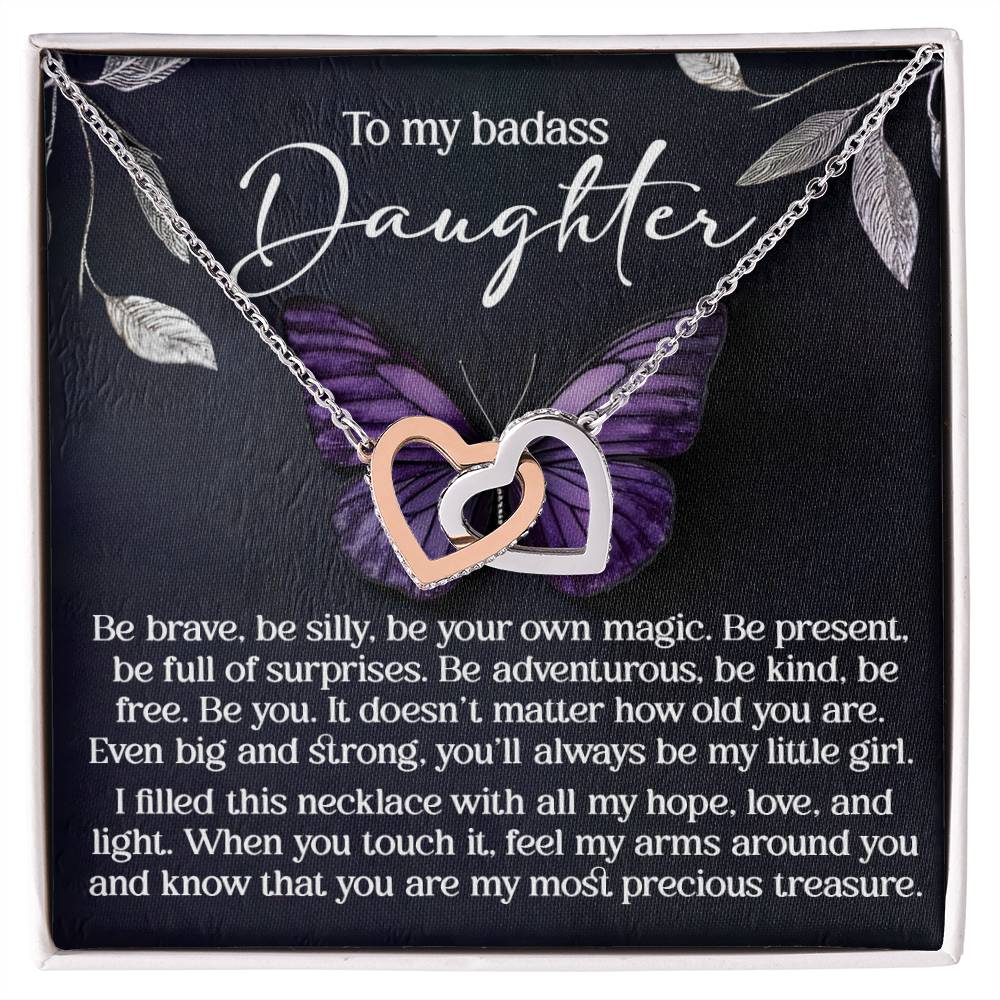 The Daughter-Big And Strong - Interlocking Hearts Necklace, finished in rose gold, features heart pendants adorned with cubic zirconia crystals. Set against a backdrop of a purple butterfly, it reads "To my badass daughter" and conveys love, strength, and cherished memories.