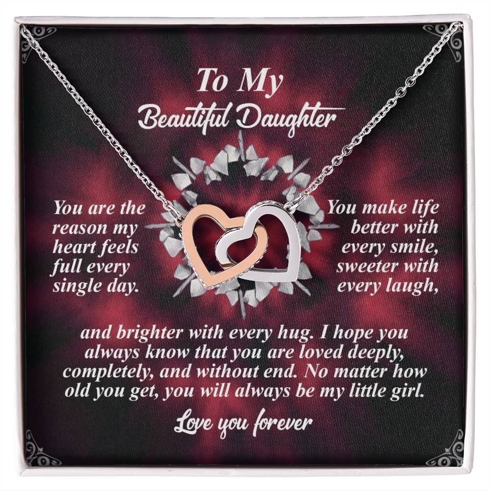 The Daughter-Every Hug - Interlocking Hearts Necklace, featuring a rose gold finish and sparkling cubic zirconia crystals, is elegantly displayed on a box with a floral background, accompanied by text celebrating a daughter's love and impact through laughter, hugs, and endless affection.