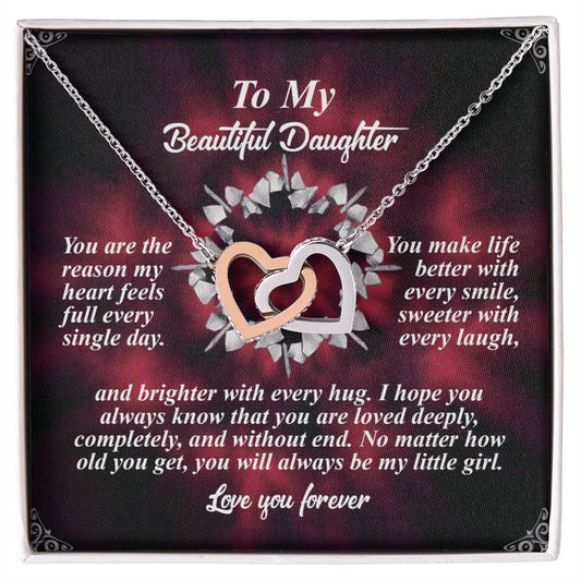 The Daughter-Every Hug - Interlocking Hearts Necklace, featuring a rose gold finish and sparkling cubic zirconia crystals, is elegantly displayed on a box with a floral background, accompanied by text celebrating a daughter's love and impact through laughter, hugs, and endless affection.