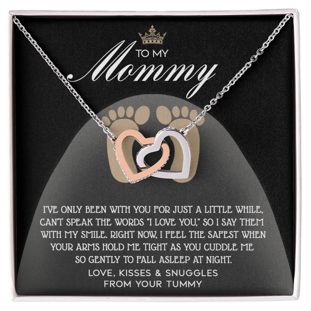 The "To Mama To Be, I Love You" Interlocking Hearts Necklace is adorned with cubic zirconia crystals and a rose gold finish, presented on a card with a heartfelt message from the baby.