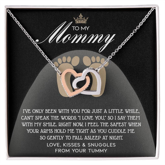 The "To Mama To Be, I Love You" Interlocking Hearts Necklace is adorned with cubic zirconia crystals and a rose gold finish, presented on a card with a heartfelt message from the baby.