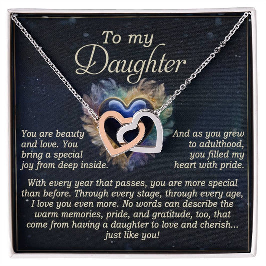 The Daughter-Like You - Interlocking Hearts Necklace features a rose gold finish and comes with a heartfelt card reading, "To my Daughter. You are beauty and love... Through every stage... you filled my heart with pride... No words can describe the warm memories... cherish... just like you.