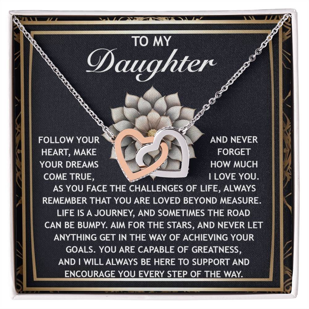 The Daughter-In The Way - Interlocking Hearts Necklace, featuring cubic zirconia crystals with a rose gold finish, is presented on a card bearing an inspirational message from a parent to their daughter.