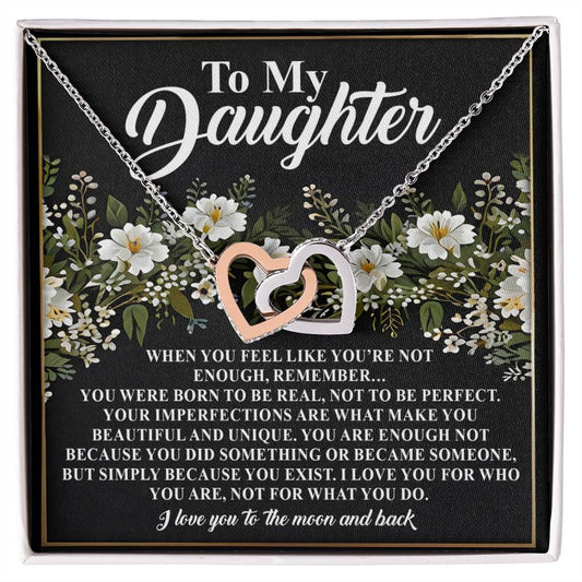 The Daughter-What You Do - Interlocking Hearts Necklace is beautifully presented on a floral black card inscribed with "To My Daughter" and a touching message on beauty, value, and love.