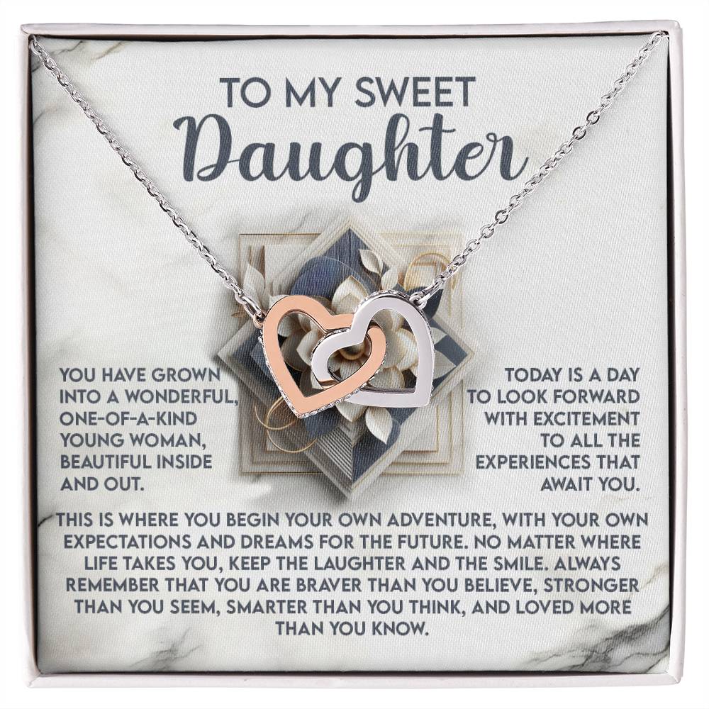 The "Daughter-For The Future" necklace features interlocking hearts with a rose gold finish, presented on a card inscribed with "To my sweet daughter," followed by an inspiring message celebrating her growth, courage, and strength to embrace bravery and live life her way.