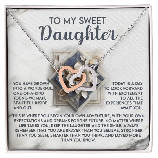 The "Daughter-For The Future" necklace features interlocking hearts with a rose gold finish, presented on a card inscribed with "To my sweet daughter," followed by an inspiring message celebrating her growth, courage, and strength to embrace bravery and live life her way.
