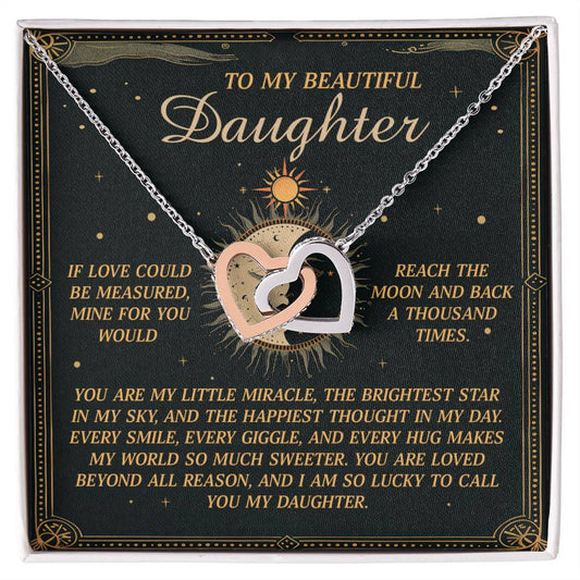 The Daughter-To Call You - Interlocking Hearts Necklace with cubic zirconia crystals comes on a green card featuring a sun design and heartfelt text expressing love to a daughter, mentioning the moon and stars.