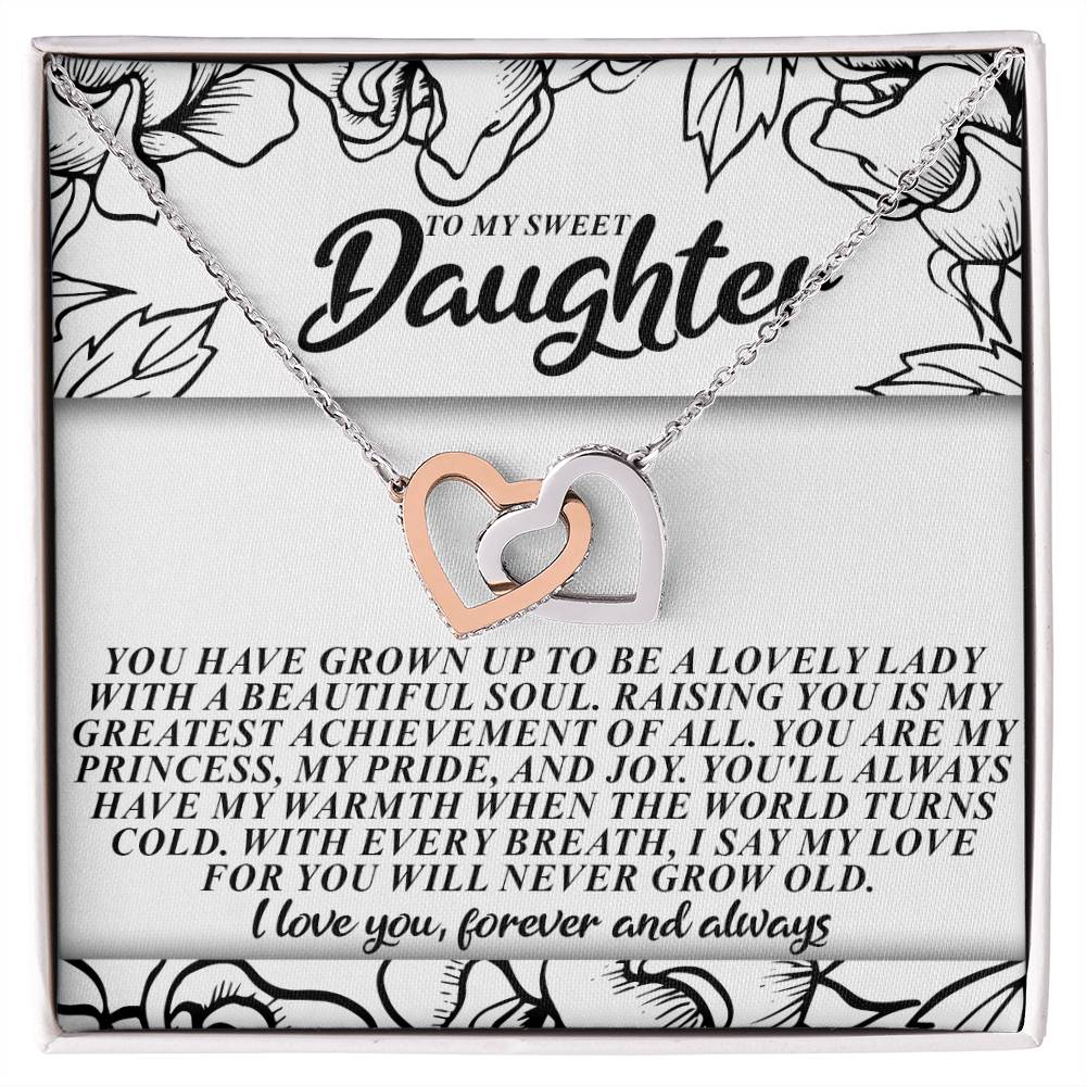The Daughter-Beautiful Soul - Interlocking Hearts Necklace includes a silver and rose gold heart with cubic zirconia crystals, elegantly presented on a floral card that reads "To my sweet daughter," with a heartfelt message of love and pride.