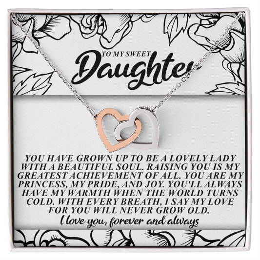 The Daughter-Beautiful Soul - Interlocking Hearts Necklace includes a silver and rose gold heart with cubic zirconia crystals, elegantly presented on a floral card that reads "To my sweet daughter," with a heartfelt message of love and pride.